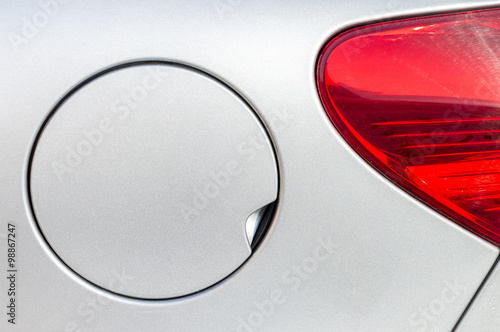 A close up of a petrol cap cover on a modern white car