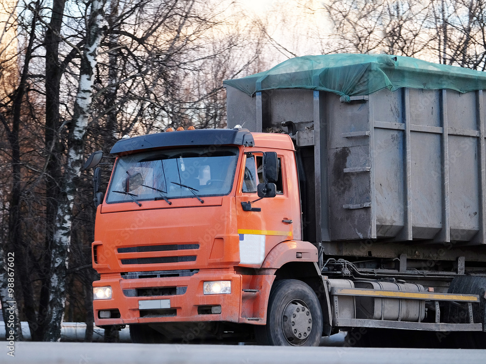 Moscow region, Russia, December, 27, 2015: The image of garbage truck on a highway in Moscow region Moscow region, Russia, December, 27, 2015: The image of garbage truck on a highway in Moscow region