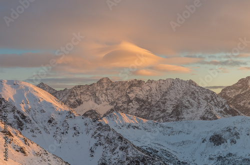 Colorful lenticular clouds over High Tatras at winter