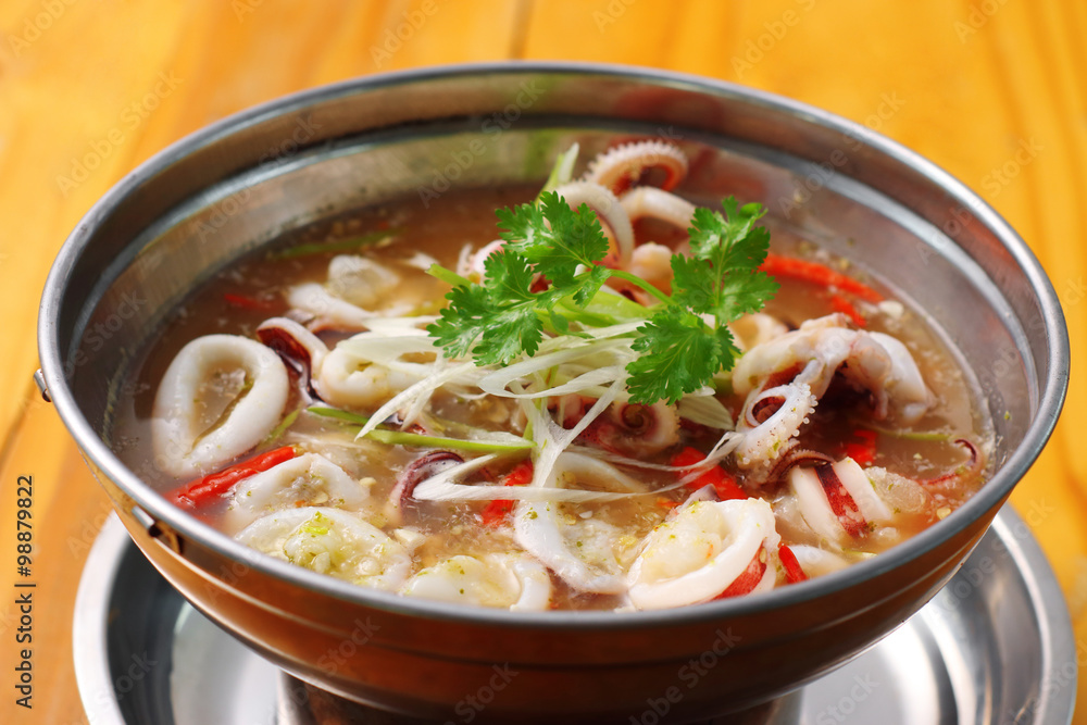 spicy squid soup in metal dish spicy squid soup in metal dish