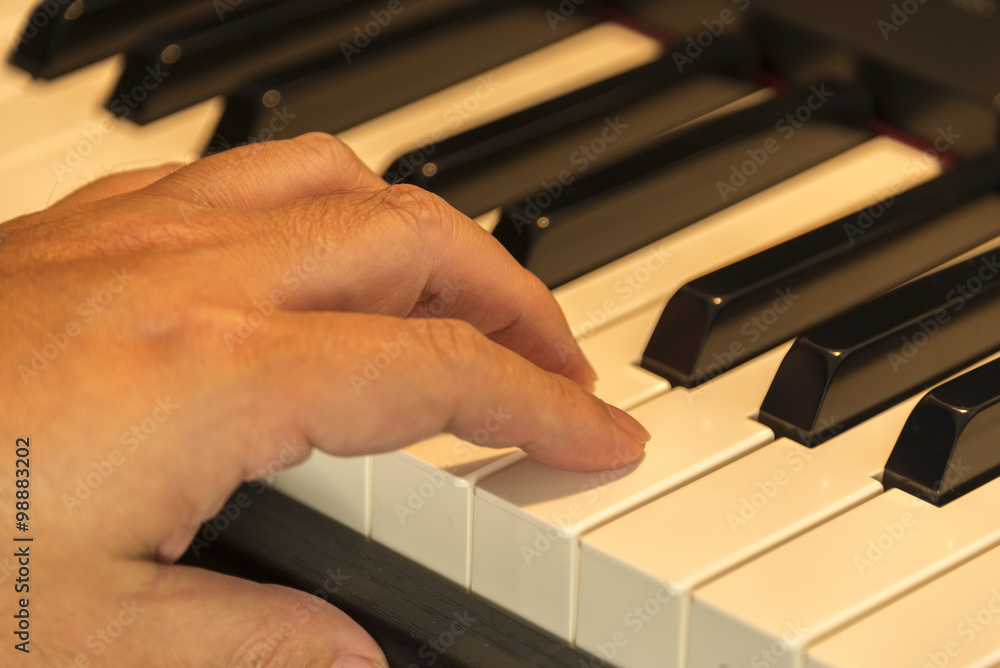Fototapeta premium close up of a hand on a piano