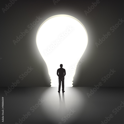 Businessman silhouette standing front of big idea lightbulb door
