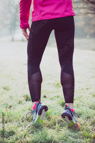 Runner woman legs on winter track, healthy lifestyle concept