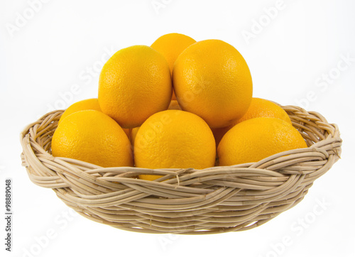 Ripe sweet tangerines in wicker basket, isolated on white
