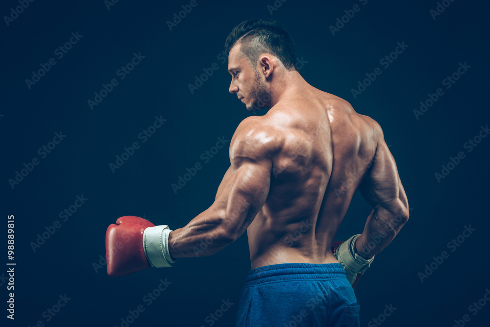 Muscular boxer in studio shooting, on black background. Muscular boxer in studio shooting, on black background.