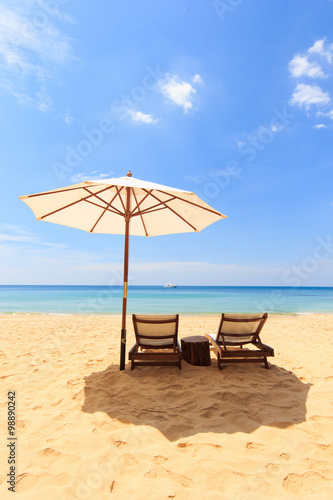 beds and umbrella on a beach © Netfalls