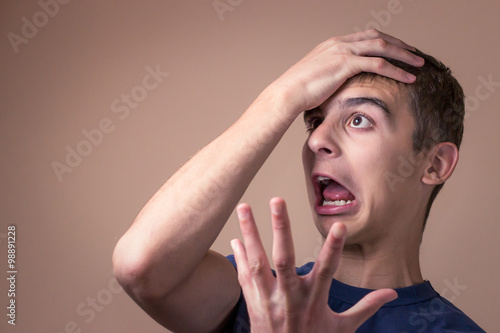 Fotografie Stressful young man. Destructive behavior. Getting upset.
