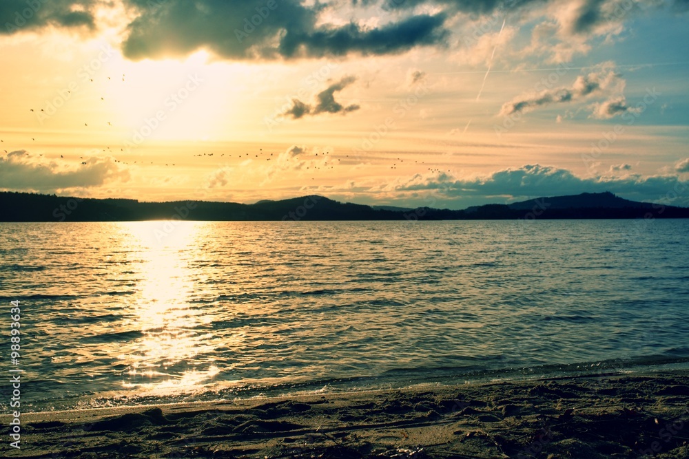 Fototapeta premium Blurred Background lighting coastline at sunset.