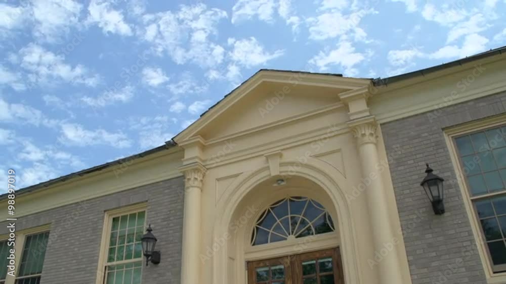 Looking up at a colonial style building and brilliant blue sky Looking up at a colonial style building and brilliant blue sky