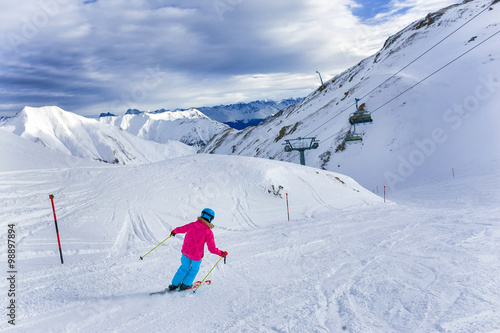 Girl skier in winter resort