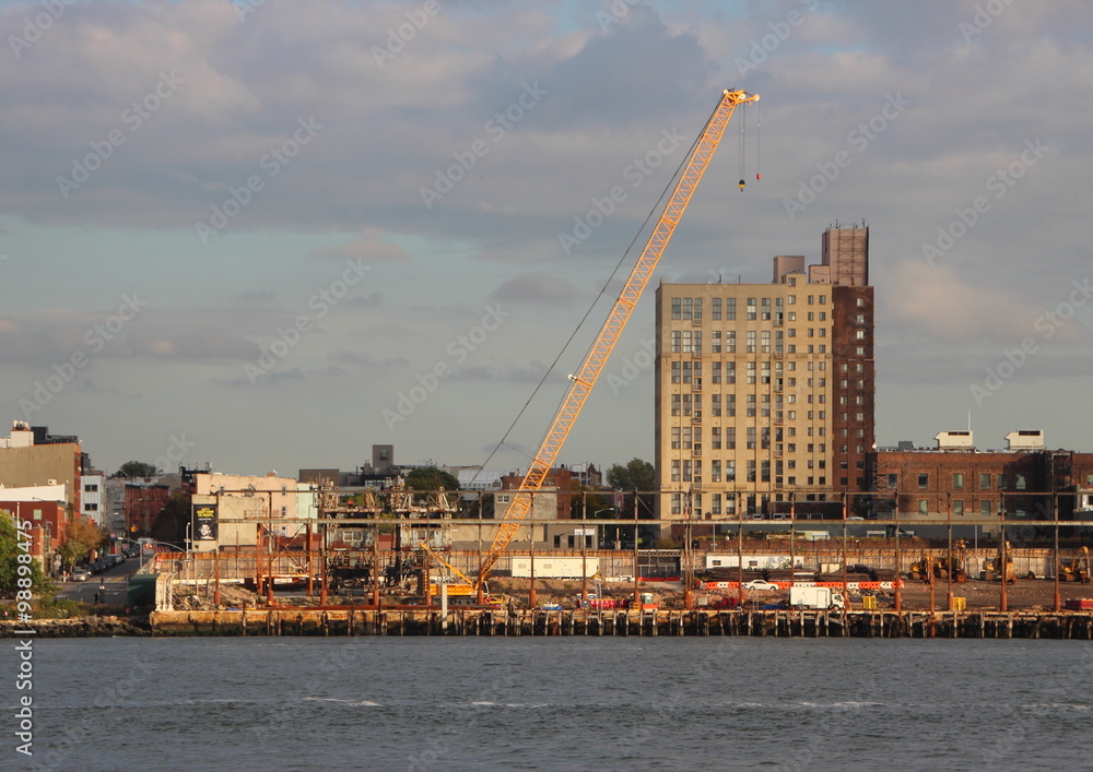 Industrial Crane at Building Site with River in Foreground