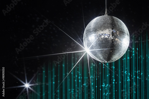 Disco ball with stars in nightclub with striped turquoise and black walls lit by spotlight, party and nightlife entertainment industry 