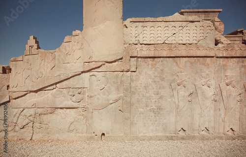 UNESCO World Heritage Site, carved animals and wariors on historical walls of ruined palace of Persepolis photo