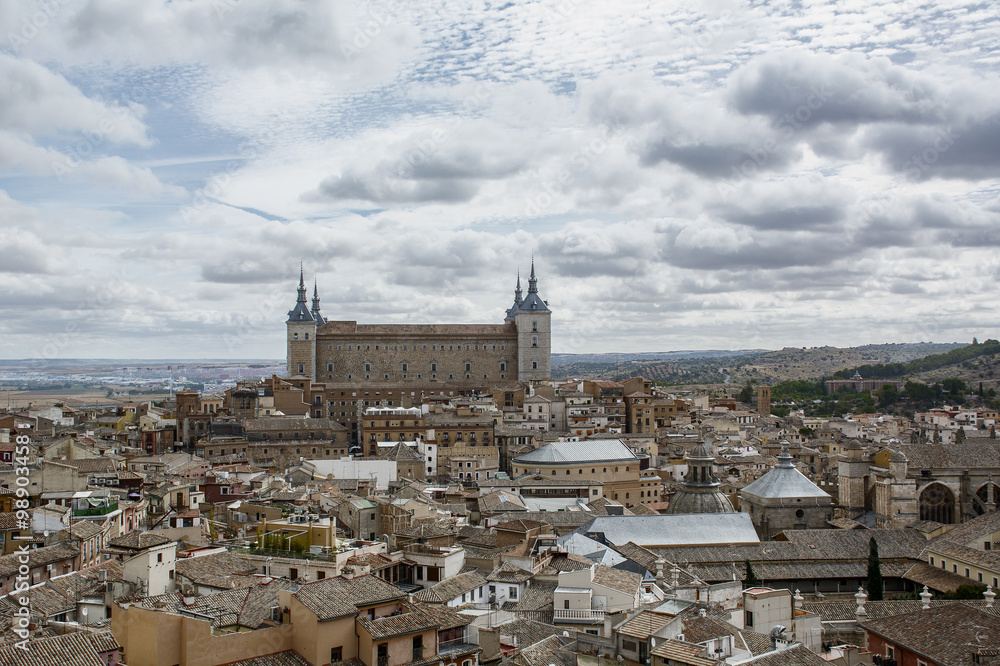 Ancient buildings under the cloudy sky in Toledo in Spain