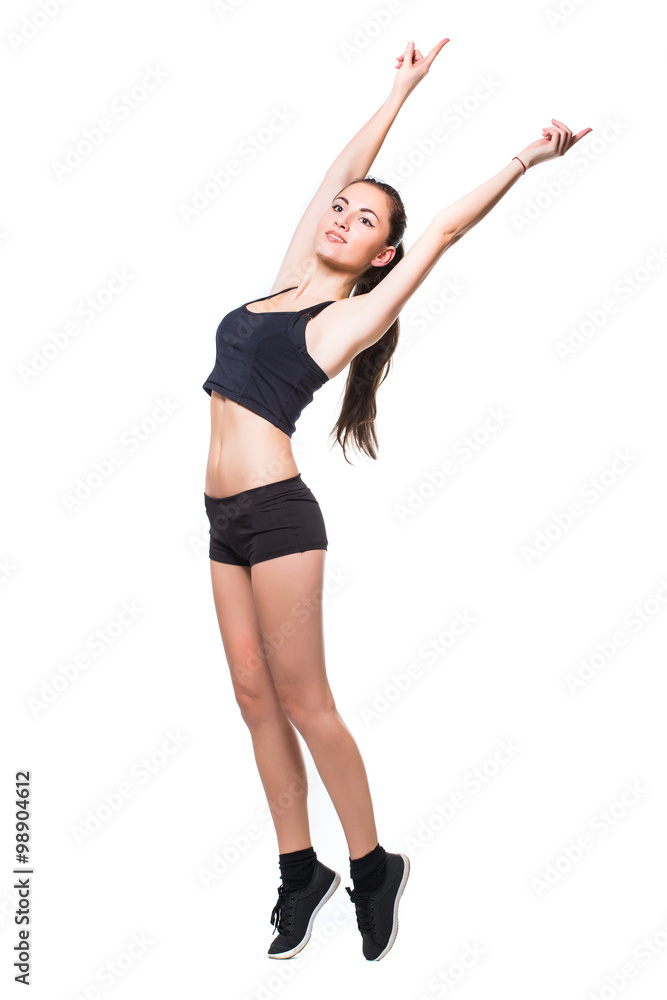 Attractive fit woman exercising in studio with copyspace. Image of healthy young female athlete doing fitness workout against grey background. Attractive fit woman exercising in studio with copyspace. Image of healthy young female athlete doing fitness workout against grey background.