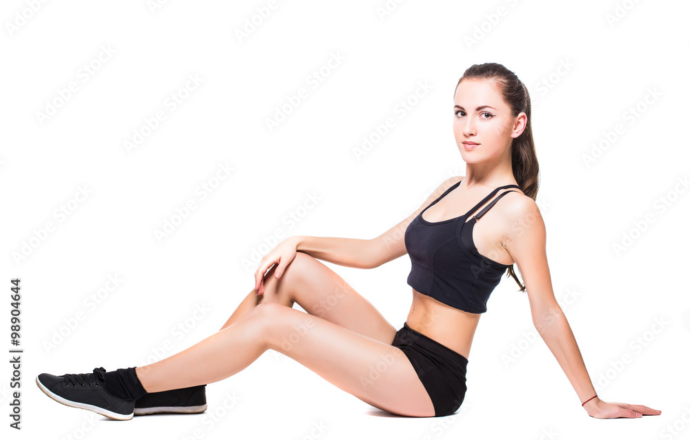 Attractive fit woman exercising in studio with copyspace. Image of healthy young female athlete doing fitness workout against grey background. Attractive fit woman exercising in studio with copyspace. Image of healthy young female athlete doing fitness workout against grey background.