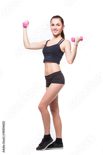 Attractive fit woman exercising in studio with copyspace. Image of healthy young female athlete doing fitness workout against grey background.