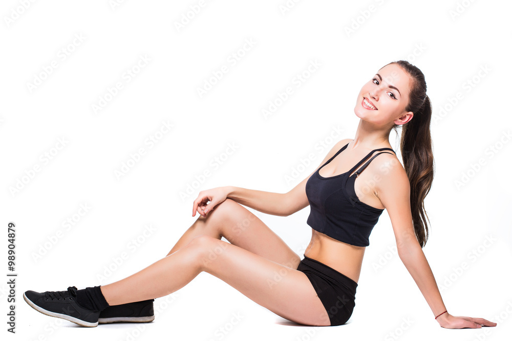 Attractive fit woman exercising in studio with copyspace. Image of healthy young female athlete doing fitness workout against grey background.