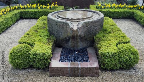 Beautiful stone fountain surrounded by box trees, Baden Baden, Germany