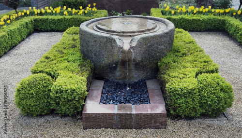 Beautiful stone fountain surrounded by box trees, Baden Baden, Germany photo