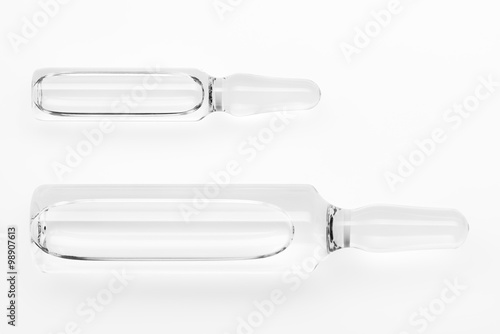 Two transparent white glass ampoules with a drug isolated on white background. Clipping path included.