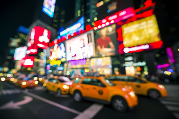 Defocus view of Times Square signage, traffic, and holiday crowds in the lead-up to New Year's Eve in New York City, USA