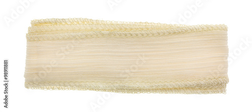 Ivory ribbon cloth material on a white background