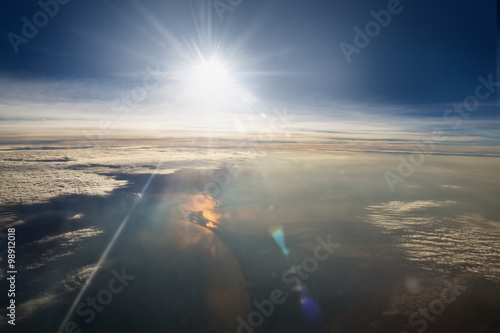 sun and clouds from an airplane window