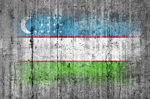 Uzbekistan flag painted on background texture gray concrete photo