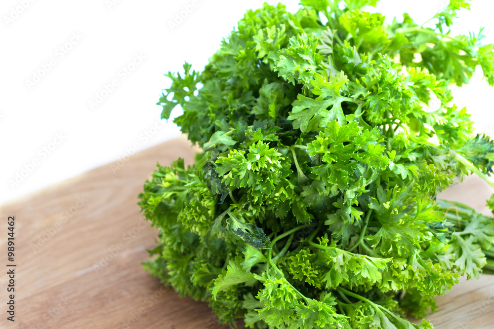 Fresh parsley on wooden cutting board Fresh parsley on wooden cutting board