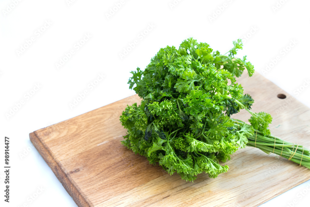 Fresh parsley on wooden cutting board Fresh parsley on wooden cutting board