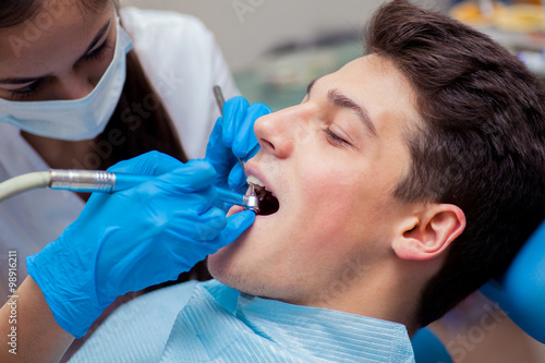 Man having teeth examined at dentists dental treatment