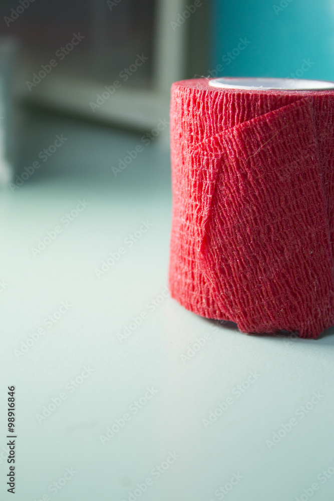 Fototapeta premium Red roll of medical adhesive tape