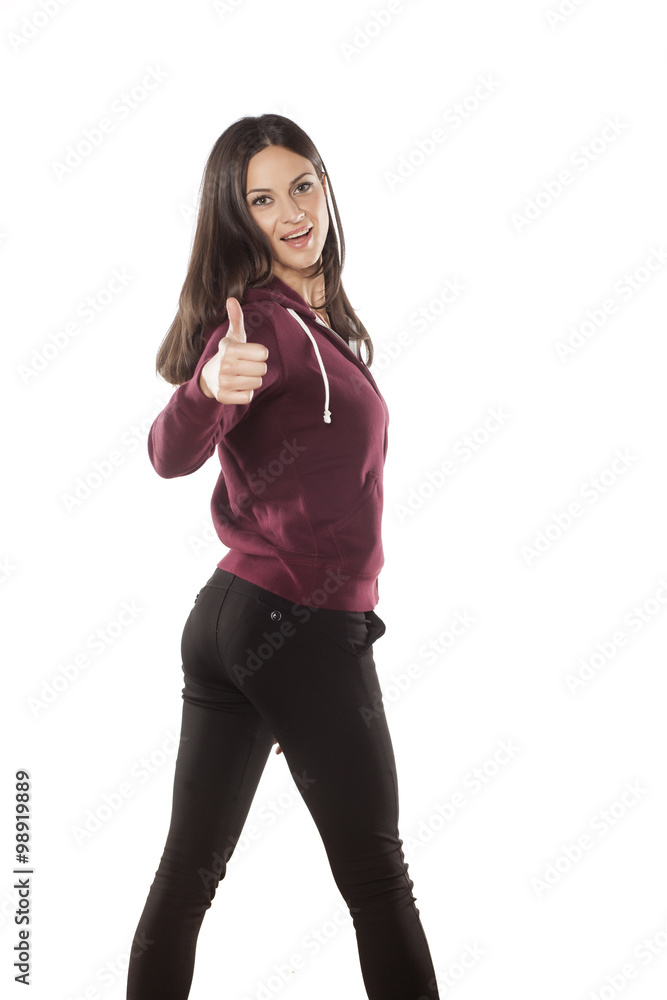 happy young woman in a tracksuit showing thumbs up happy young woman in a tracksuit showing thumbs up