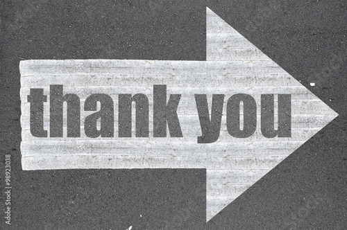 Arrow on asphalt road written word thank you