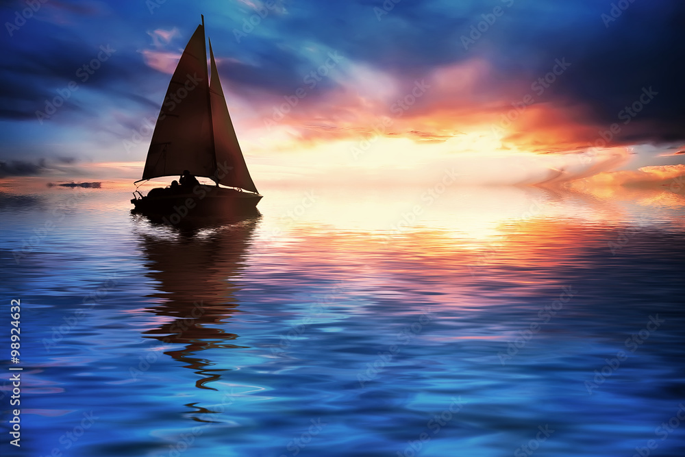Yacht sailing against sunset