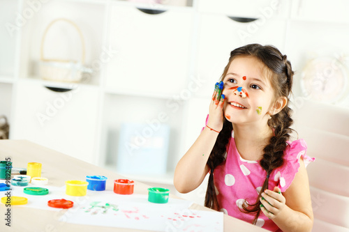 Cute little girl painting p...
