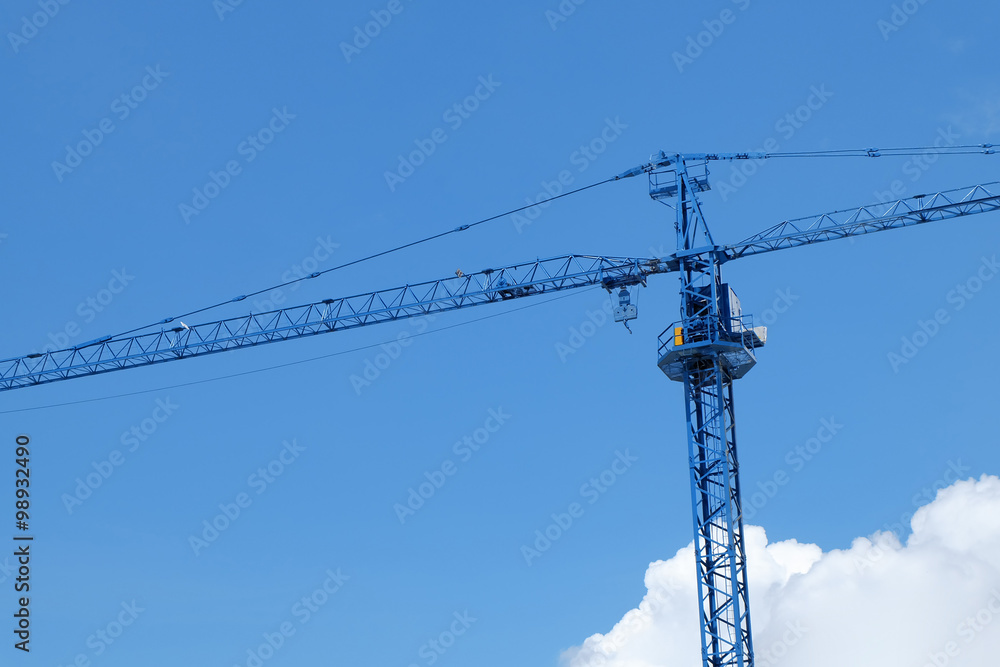 large construction crane machine with clear blue sky background large construction crane machine with clear blue sky background