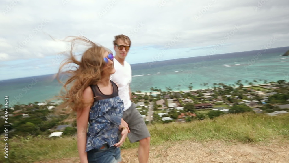 Hiking happy couple walking holding hands in trail Pillbox Hike, Oahu, Hawaii. Hiking happy couple walking holding hands in trail Pillbox Hike, Oahu, Hawaii.