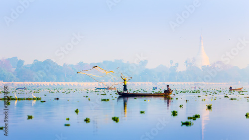 MANDALAY - FEB 19 : A man throw net for catching fish in Taungth