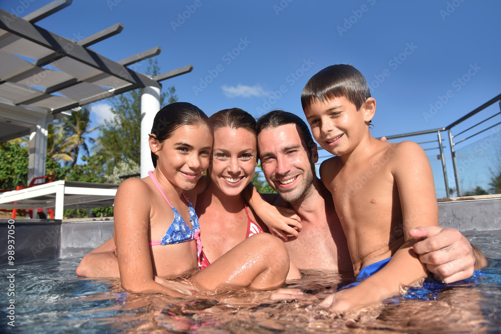 Fototapeta premium Happy family in swimming-pool, summertime