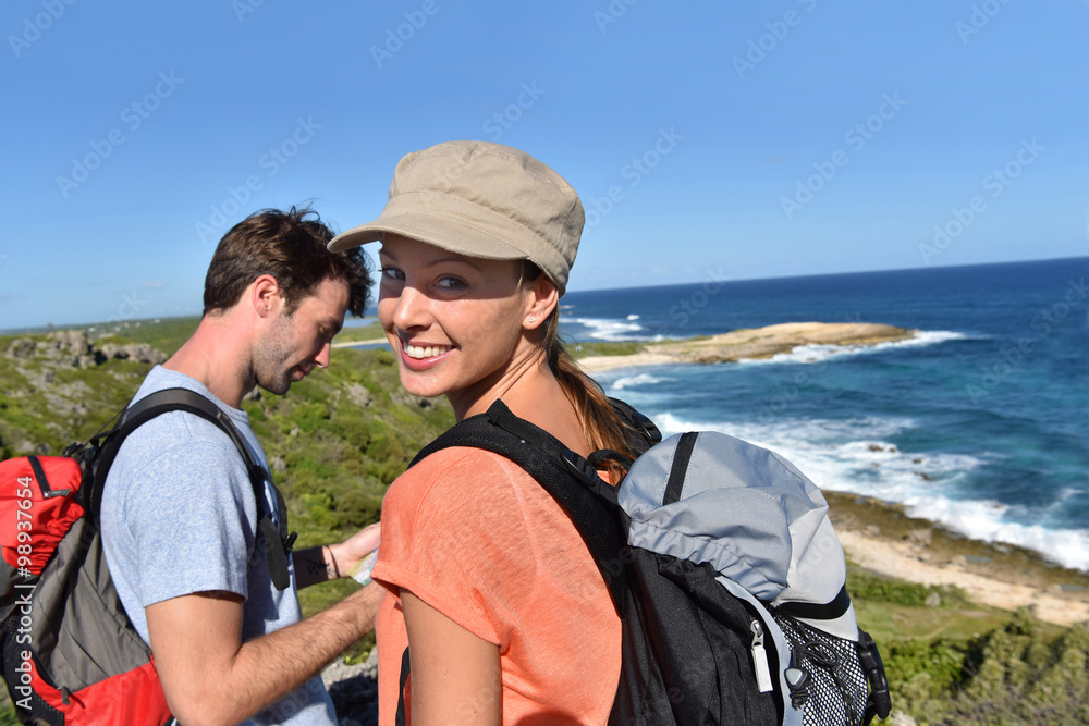 Couple of hikers looking at map and scenery