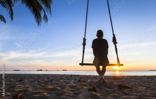 Lonely woman thinking about life on a beach at sunset