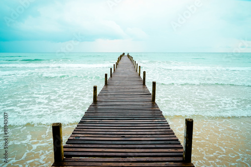 Wooden pier toward the fresh breeze sea