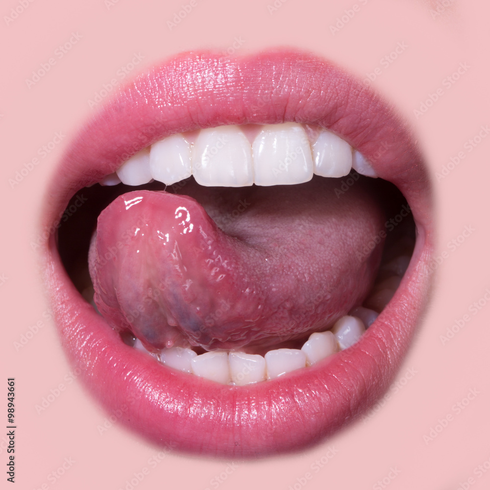 Fototapeta premium Closeup view of female smiling happy opne mouth with soft pink natural lips and white clean perfect healthy beautiful teeth and licking tongue on medical dental beige background, square picture