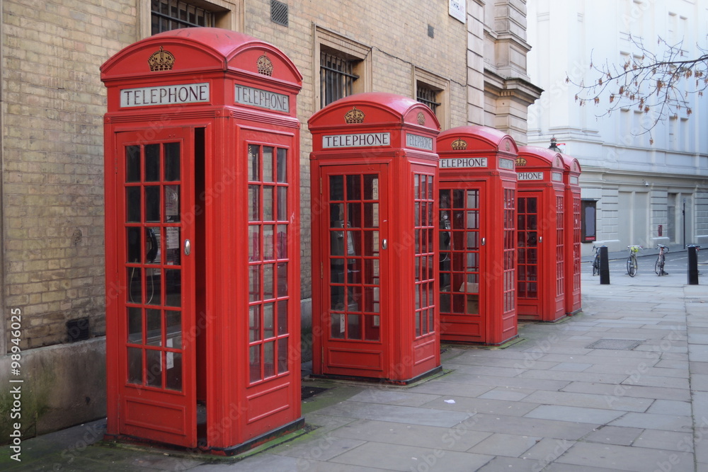 Traditional British red telephone boxes in a row Traditional British red telephone boxes in a row
