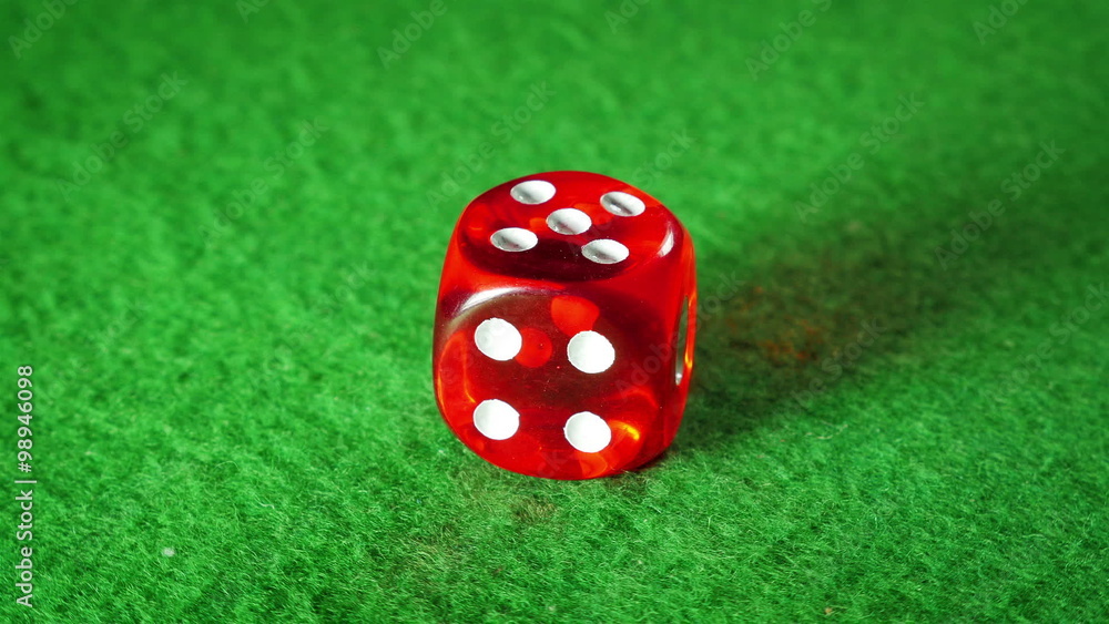 Red dice on the green cloth background. Rotation. Number 5. Red dice on the green cloth background. Rotation. Number 5.