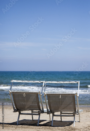 two beach chairs with blue sky