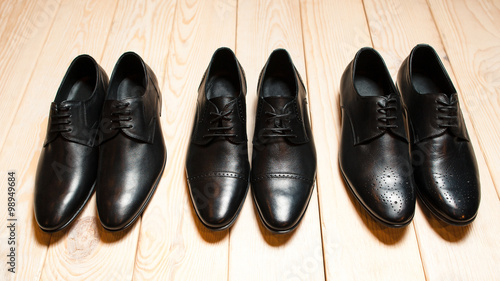 set of men's leather shoes on wood