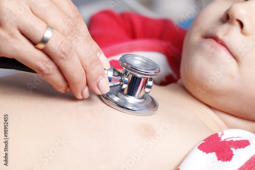 Young woman doctor cardiologist makes a survey